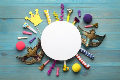 Photo of Flat lay composition with carnival items and blank card on light blue wooden background. Space for text