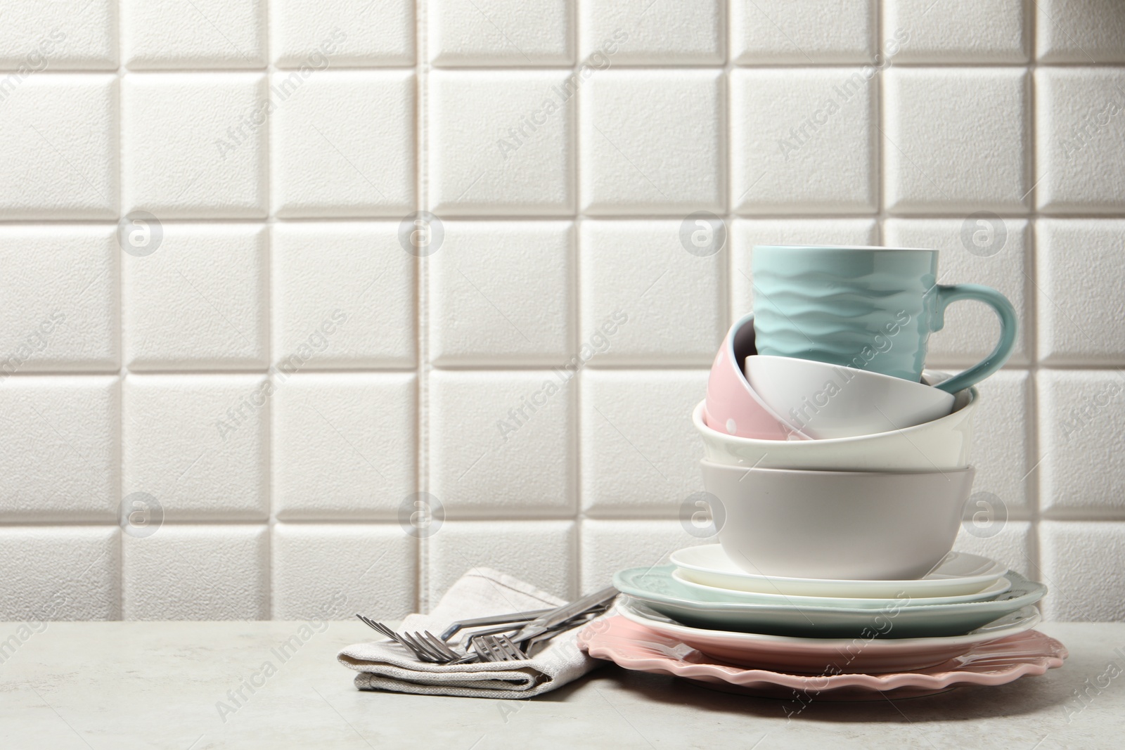 Photo of Beautiful ceramic dishware, cup and cutlery on light grey table, space for text