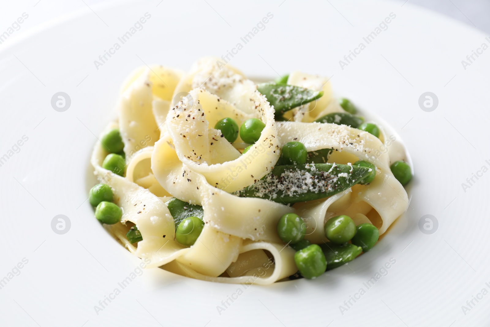 Photo of Delicious pasta with green peas on plate