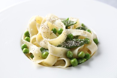 Photo of Delicious pasta with green peas on plate