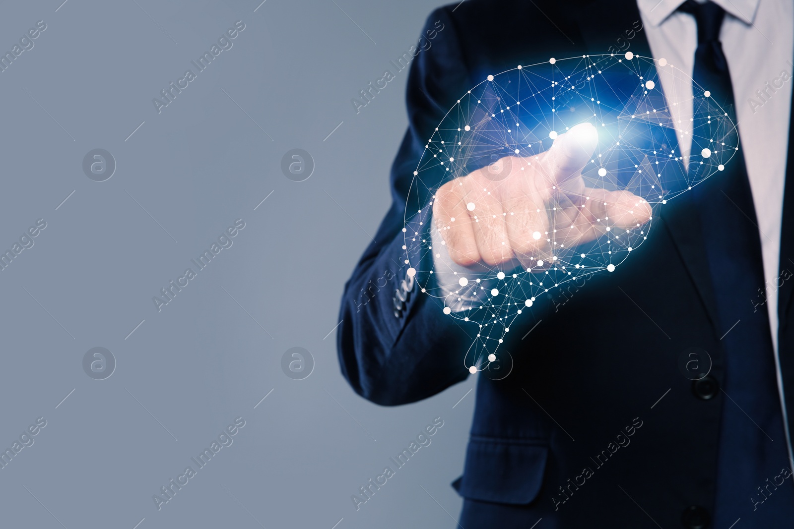 Image of Young man pointing at digital image of brain on grey background, closeup. Space for text 