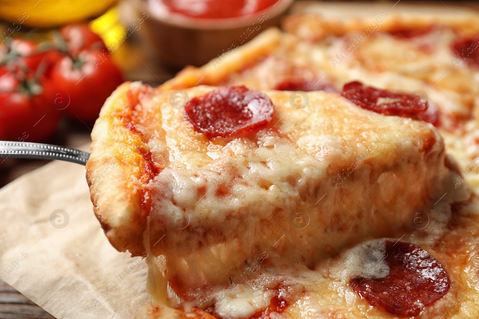 Photo of Taking slice of tasty pepperoni pizza on table, closeup