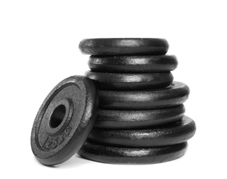 Photo of Many different weight plates on white background. Sporting equipment