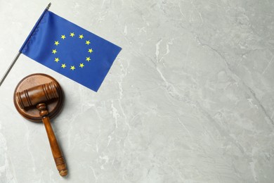 Judge's gavel and flag of European Union on light grey marble table, flat lay. Space for text