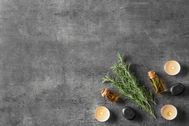 Photo of Flat lay composition with fresh rosemary oil on grey background