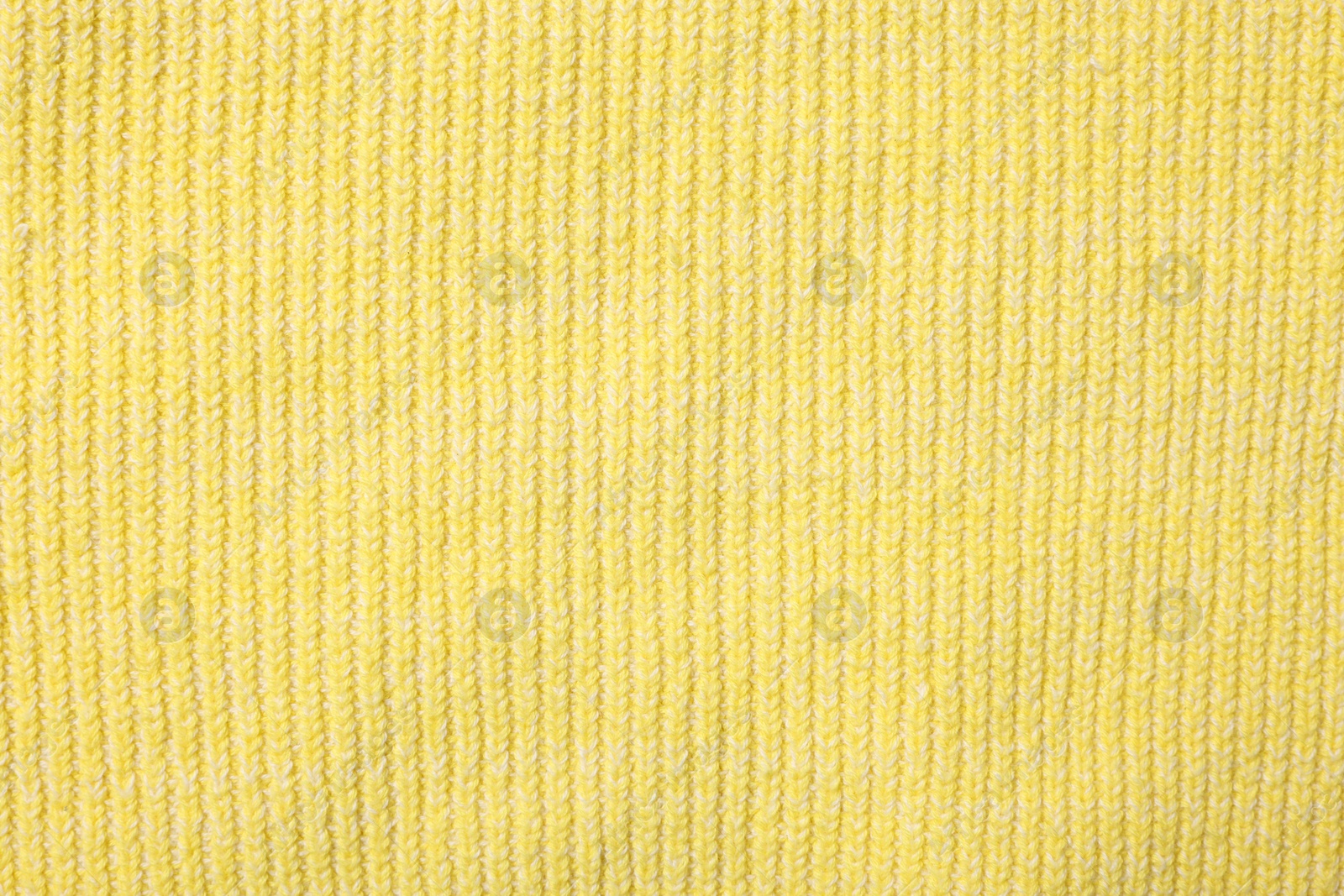 Photo of Texture of soft yellow fabric as background, top view