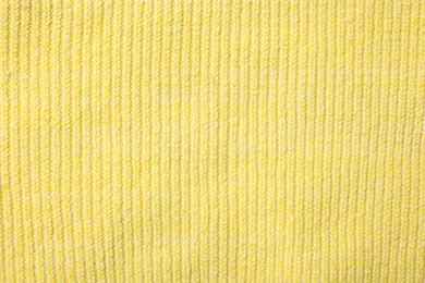 Photo of Texture of soft yellow fabric as background, top view