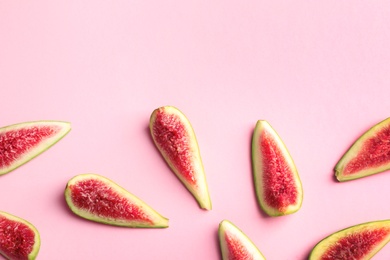 Photo of Fresh ripe fig slices on color background, top view. Space for text