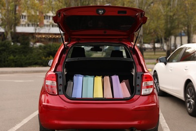 Car trunk full of shopping bags outdoors