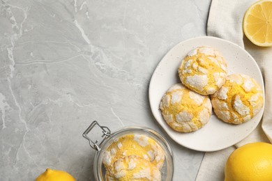 Photo of Flat lay composition with tasty lemon cookies on grey table. Space for text