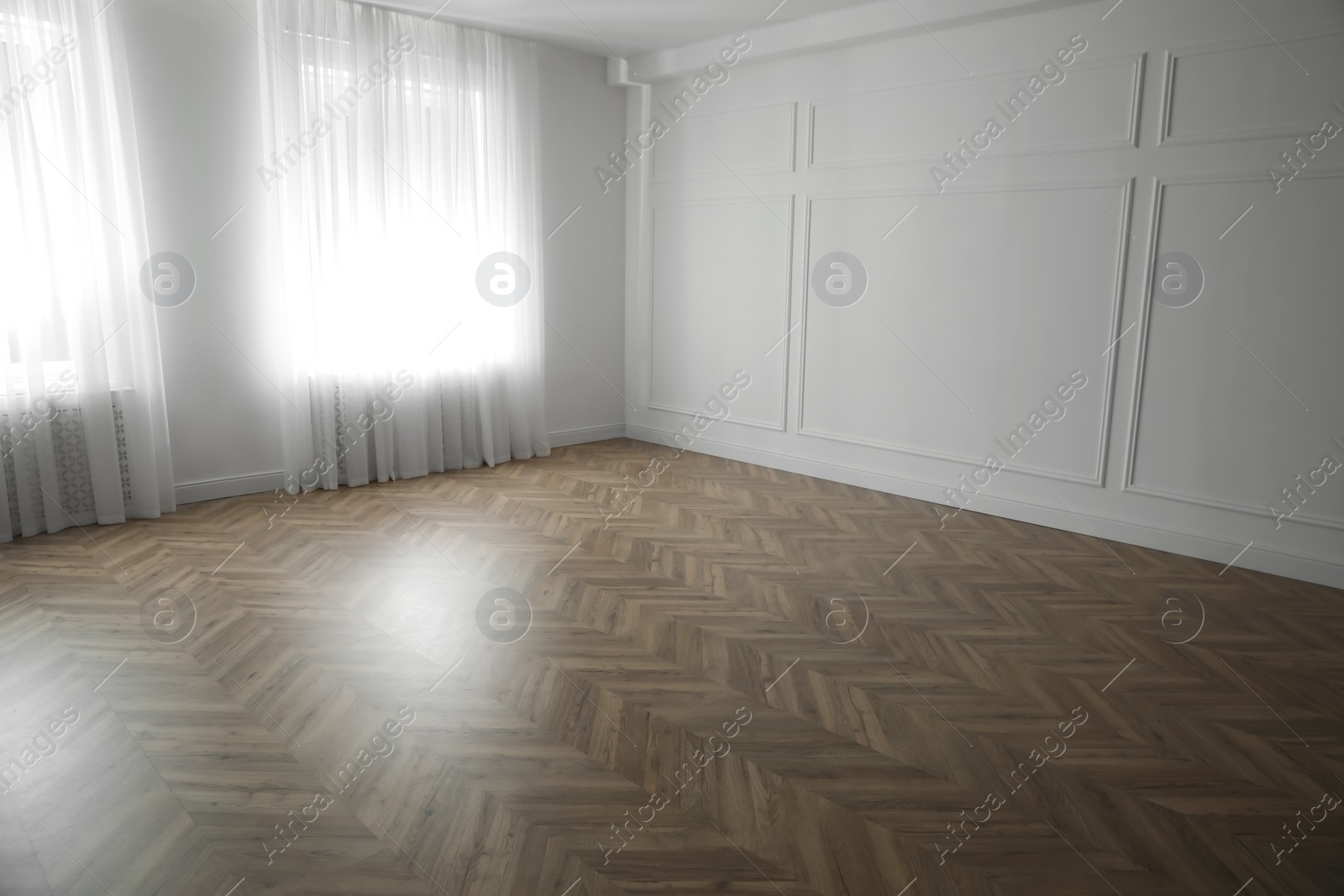 Photo of Parquet floor in light spacious empty room