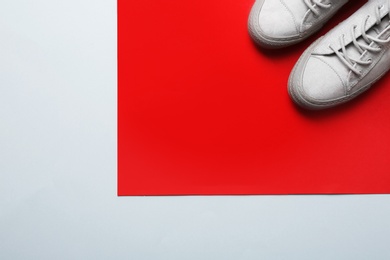 Photo of Stylish sneakers on color background, top view with space for text