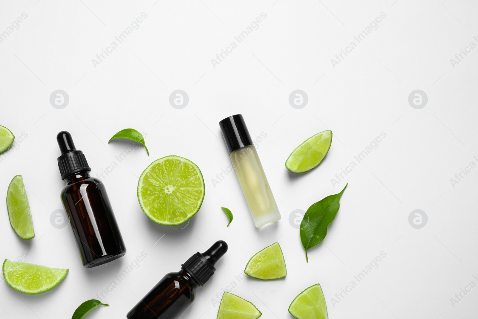 Photo of Composition with lime essential oil on white background, top view