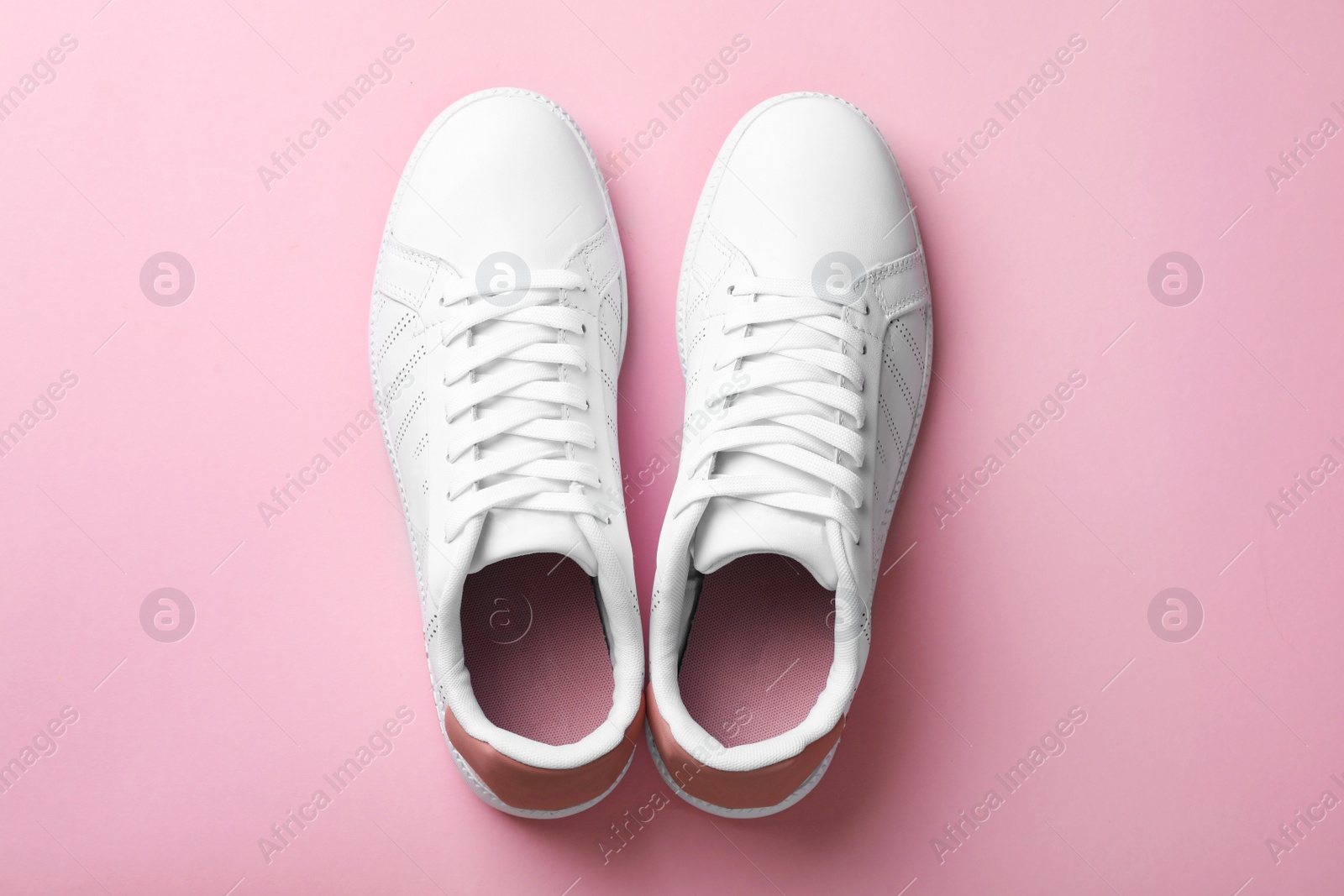 Photo of Pair of sneakers on color background, flat lay