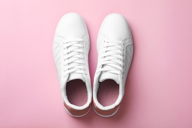 Photo of Pair of sneakers on color background, flat lay