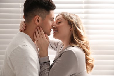 Photo of Lovely couple enjoying time together at home