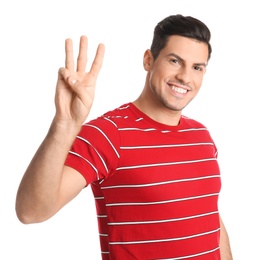 Photo of Man showing number three with his hand on white background