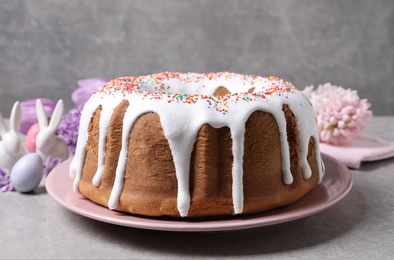 Glazed Easter cake with sprinkles on grey table