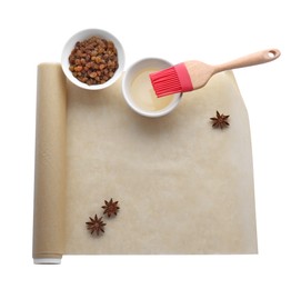 Photo of Roll of baking parchment paper and different ingredients isolated on white, top view