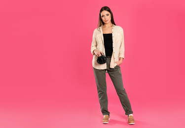 Professional photographer working on pink background in studio. Space for text