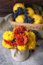 Photo of Bouquet of beautiful chrysanthemum flowers on grey table