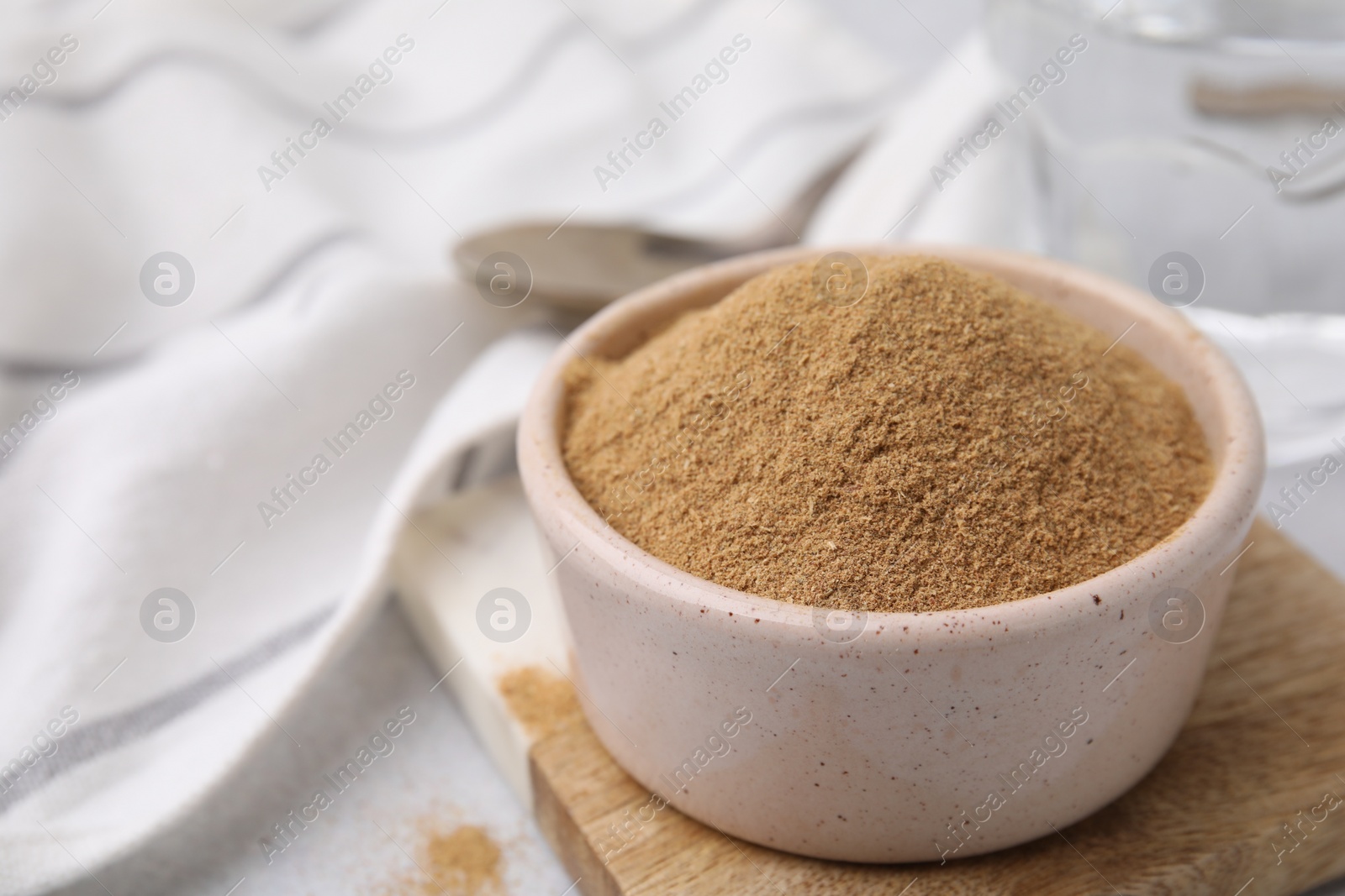 Photo of Dietary fiber. Psyllium husk powder in bowl on table, closeup