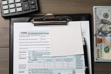 Photo of Flat lay composition with tax return form on wooden table