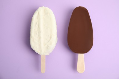 Photo of Glazed ice cream bars on lilac background, flat lay