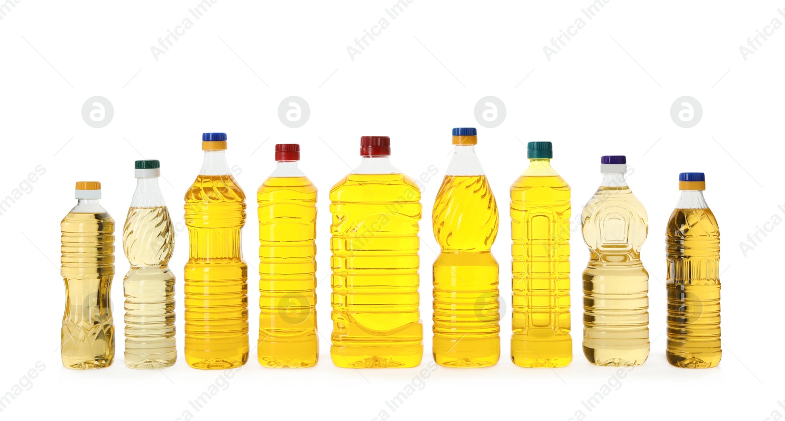 Photo of Cooking oil in different bottles isolated on white