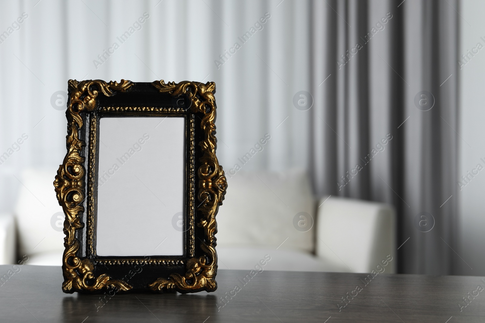 Photo of Beautiful vintage empty frame on wooden table, space for text