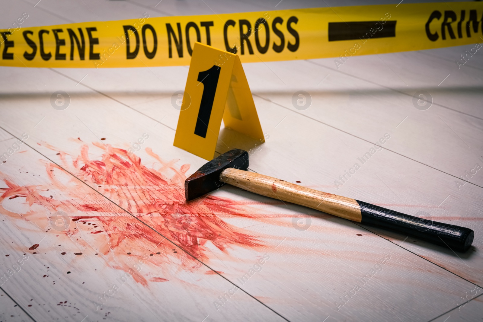 Photo of Hammer with blood and crime scene marker on white wooden background