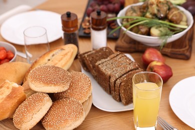 Healthy vegetarian food and glass of juice on wooden table