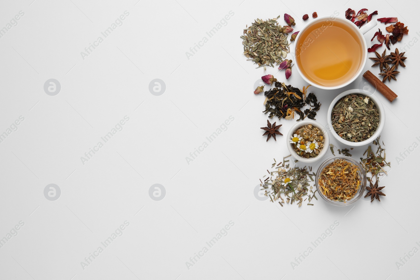 Photo of Composition with fresh brewed tea and dry leaves on white background, top view