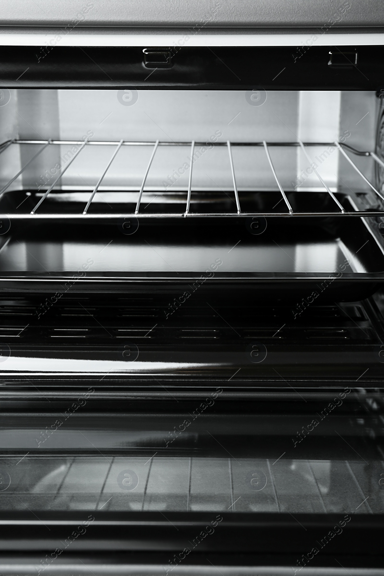 Photo of Open electric oven, closeup view. Cooking appliance