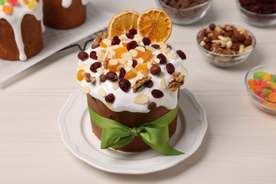 Tasty Easter cakes with dried fruits and nuts on white wooden table