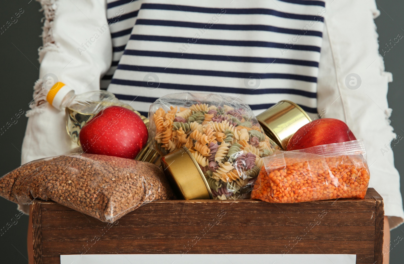 Photo of Person holding donation box with food, closeup