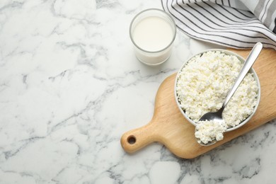 Delicious fresh cottage cheese and milk on white marble table, flat lay. Space for text