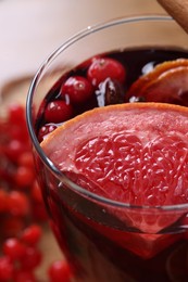 Aromatic mulled wine in glass on table, closeup