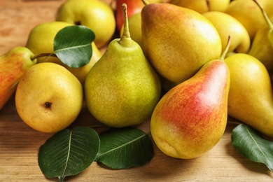 Photo of Ripe pears on wooden table. Healthy snack