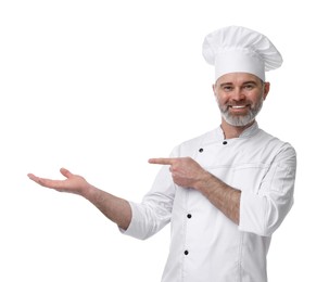 Happy chef in uniform pointing at something on white background