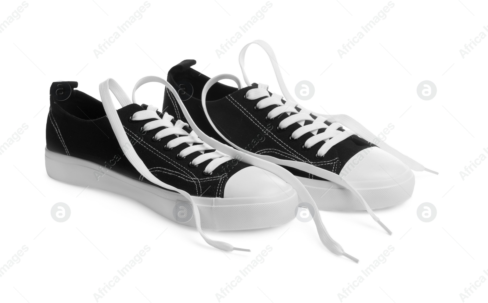 Photo of Pair of black classic old school sneakers isolated on white