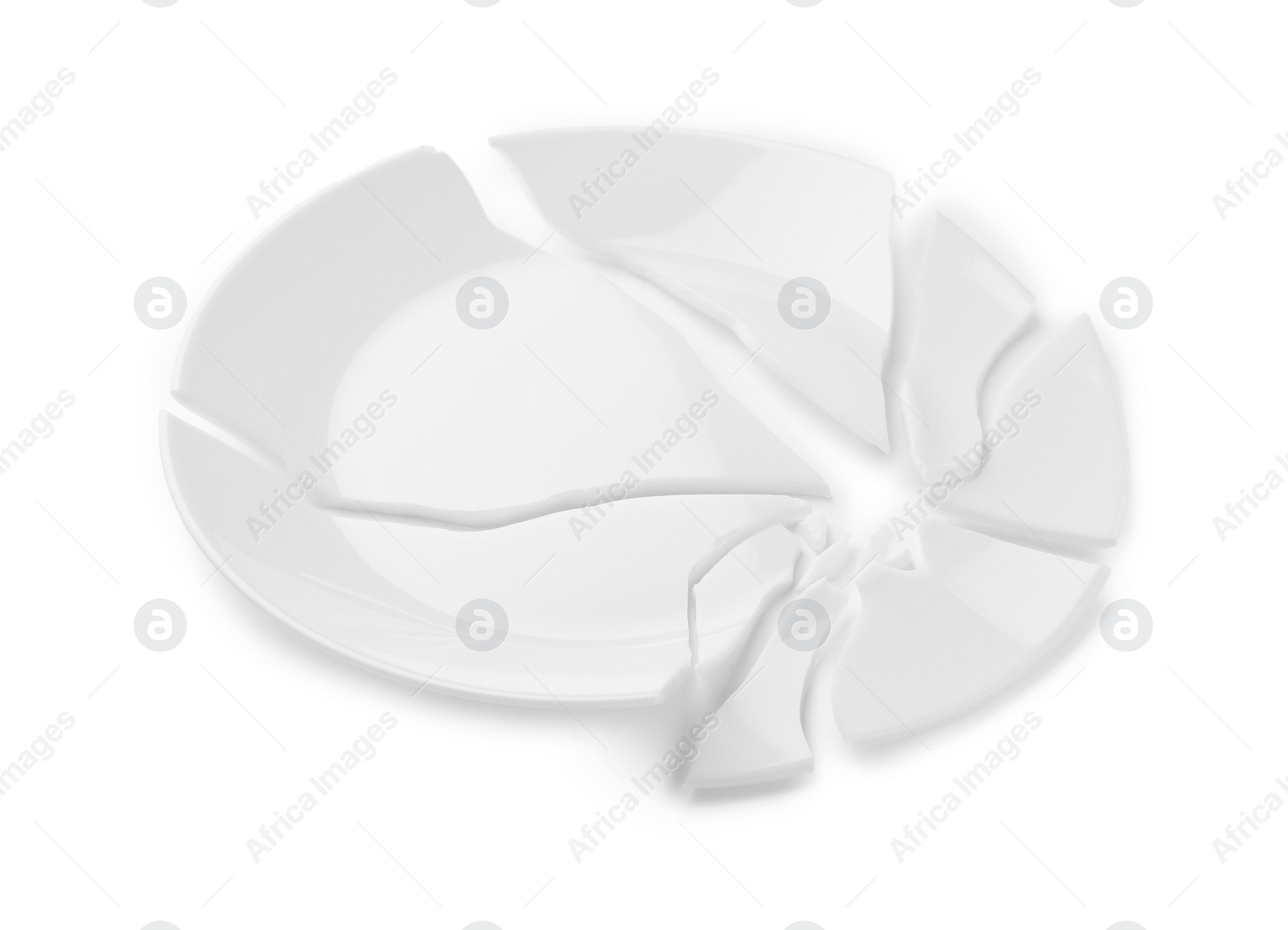 Photo of Pieces of broken ceramic plate on white background