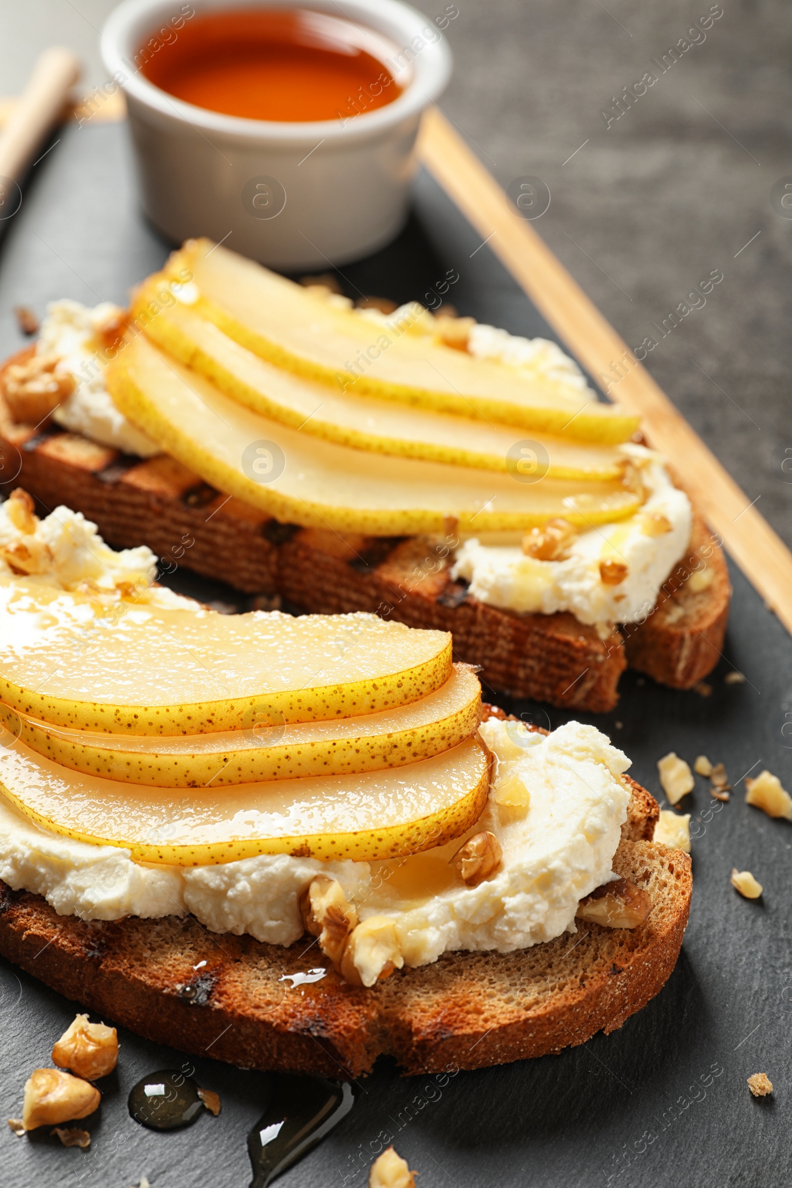 Photo of Toasted bread with cream cheese and pear on board