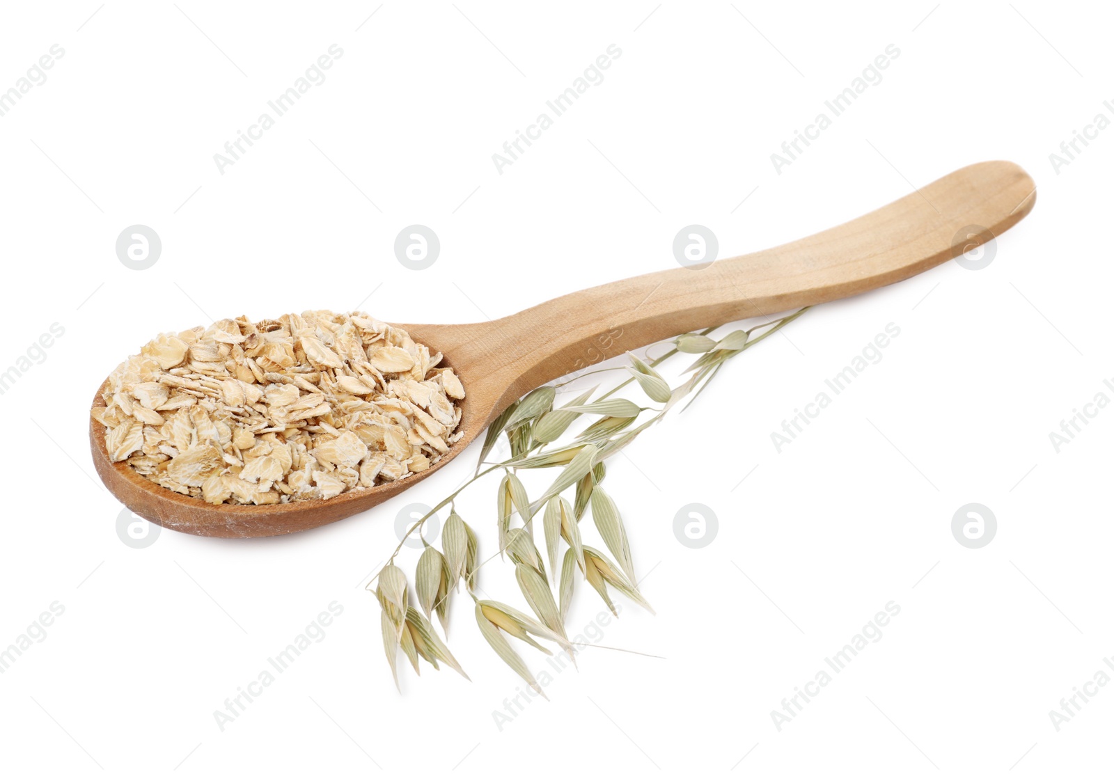 Photo of Wooden spoon of oatmeal and branch with florets isolated on white