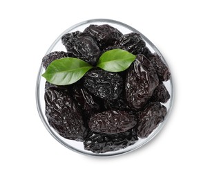 Photo of Bowl with sweet dried prunes and green leaves isolated on white, top view