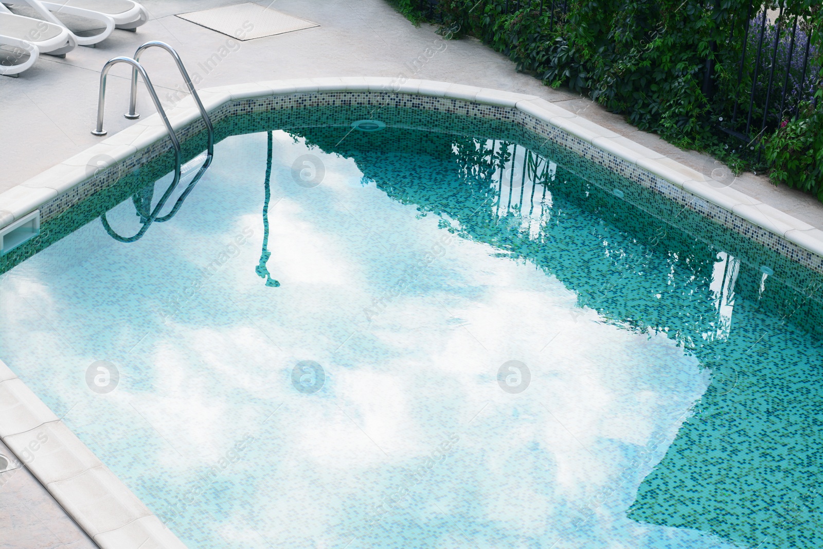 Photo of Ladder with grab bars in outdoor swimming pool