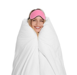 Young woman in sleeping mask wrapped with soft blanket on white background