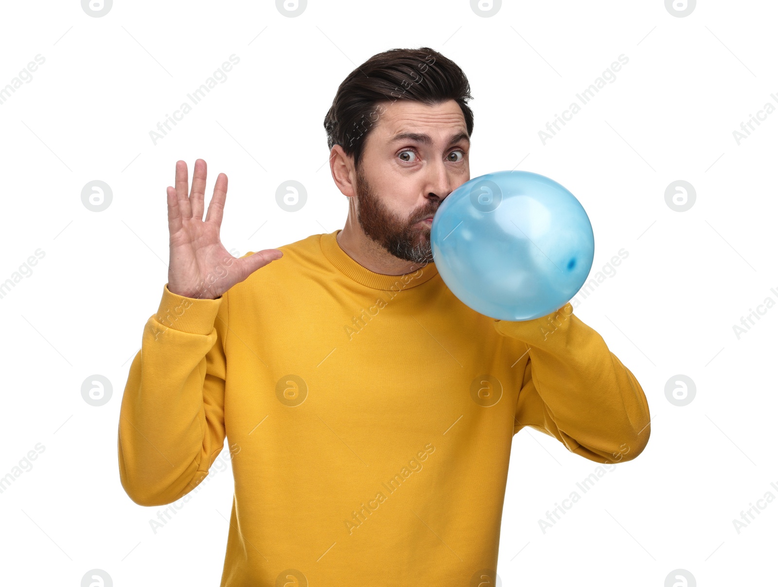 Photo of Man inflating light blue balloon on white background