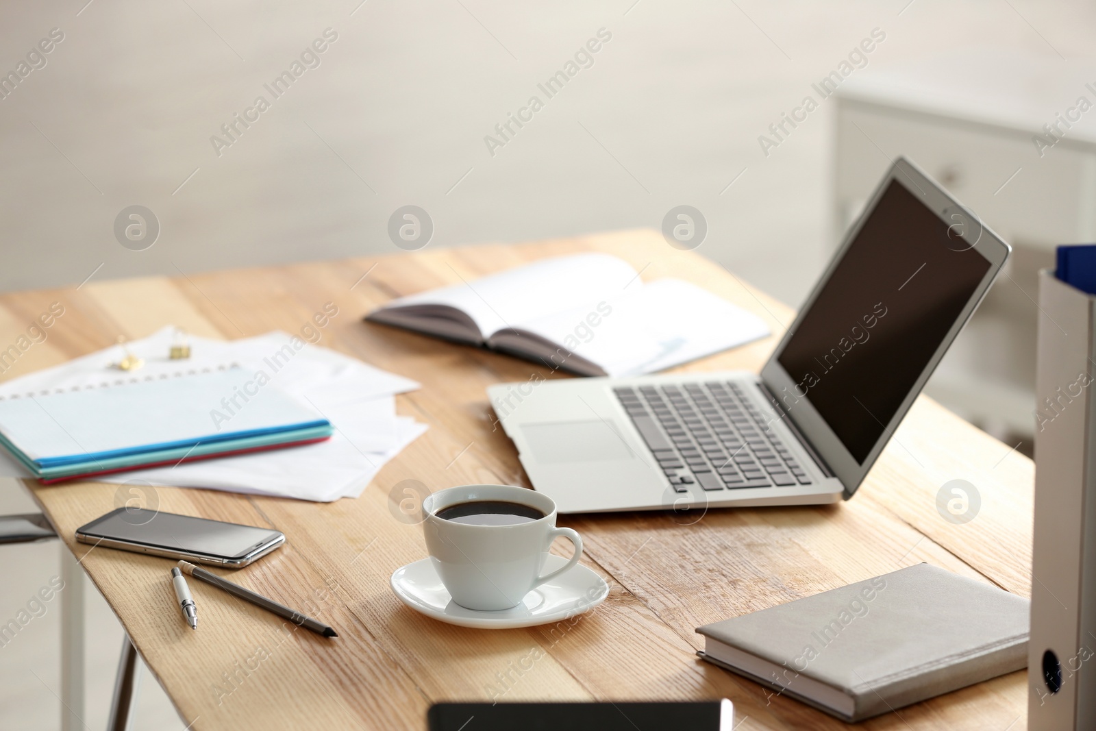 Photo of Modern laptop and supplies on table in office