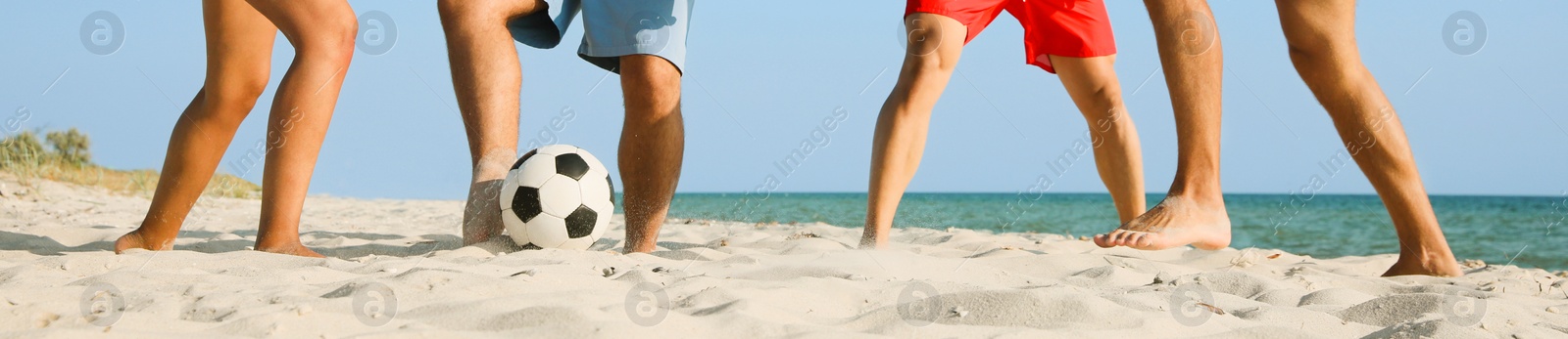 Image of Group of friends playing football on sandy beach, closeup. Banner design